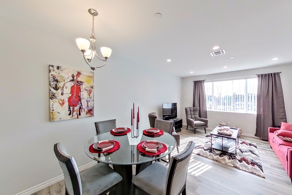 a dining room with a glass table and chairs