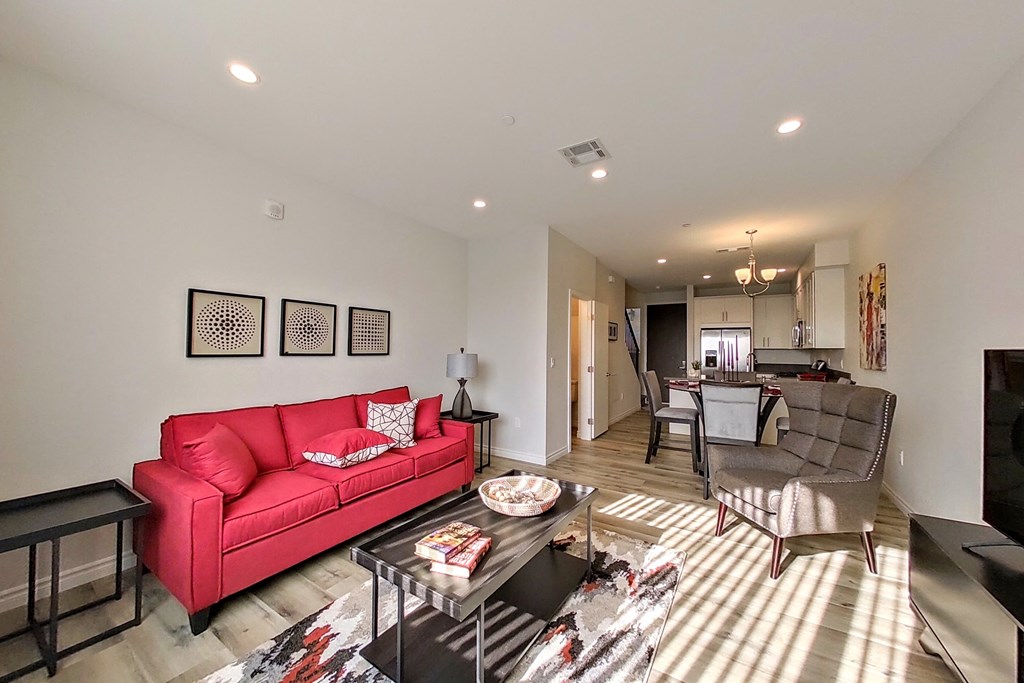 a living room with a red couch and a table