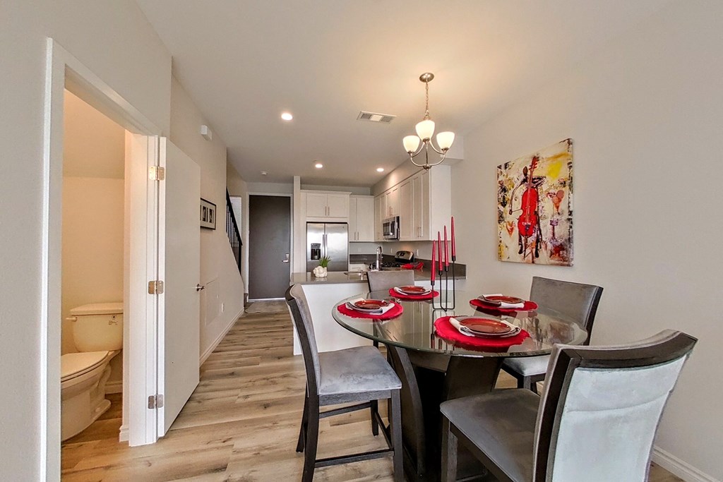 a dining room with a table and chairs and a kitchen