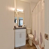 a bathroom with a toilet and a sink and a shower curtain