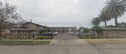 A residential area with houses and parked cars.