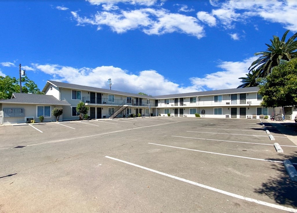 the view of an empty parking lot in front of a hotel building