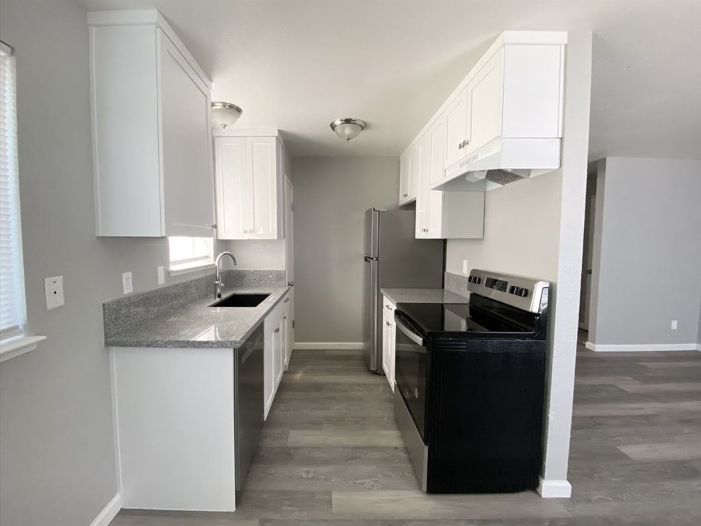 a kitchen with black appliances and white cabinets
