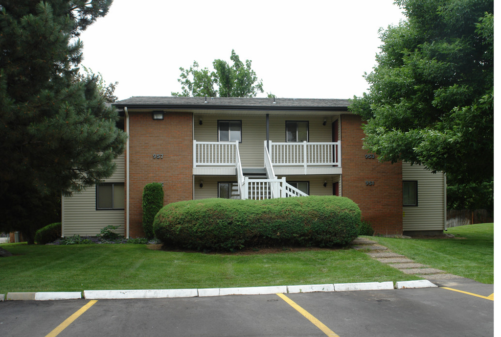the view of an apartment building from the street