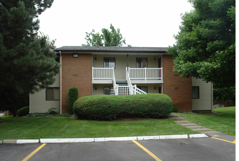 the view of an apartment building from the street