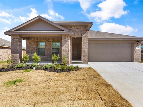 A house with a brown roof and a garage door.