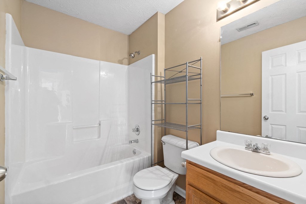 a bathroom with a shower toilet and sink