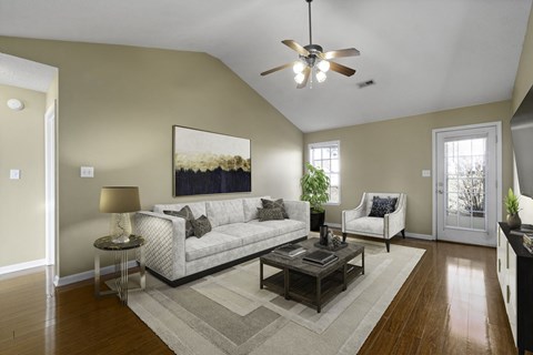 a living room with a ceiling fan and a couch