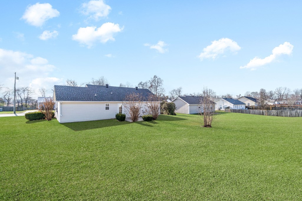 a white house in the middle of a field