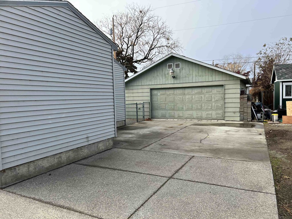 a garage door on the side of a house with a driveway