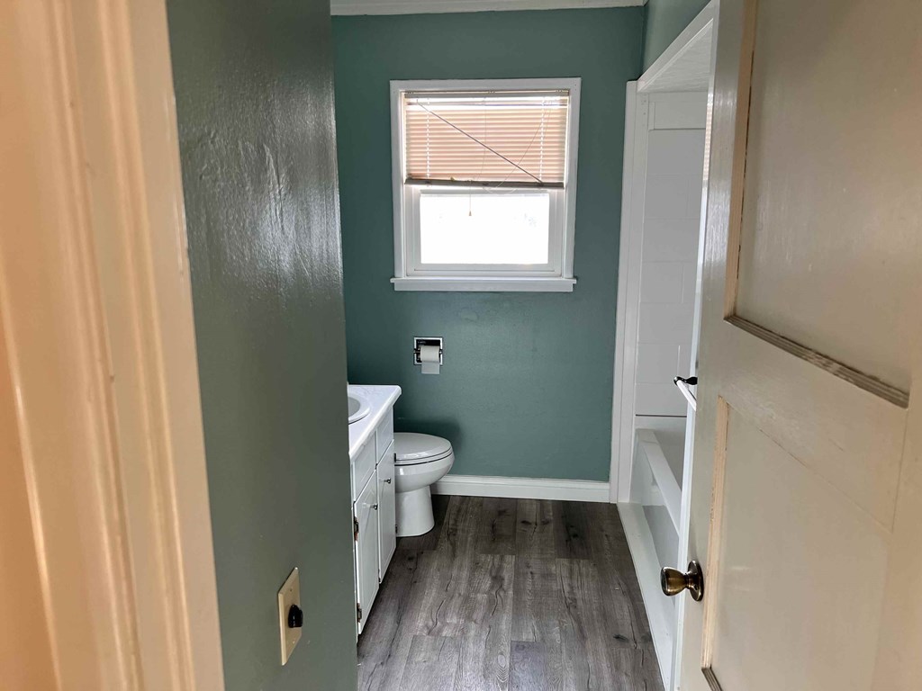 a small bathroom with a toilet and a window