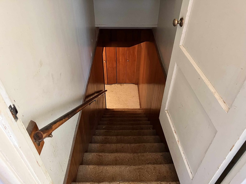 a set of stairs with a hand rail and a door