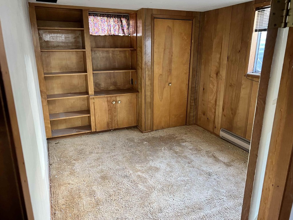 a room with wooden shelves and a carpeted floor