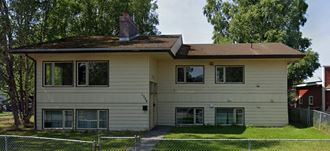 a white house with a roof on top of it