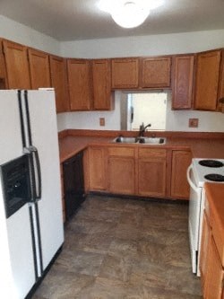 A kitchen with wooden cabinets and a white refrigerator.