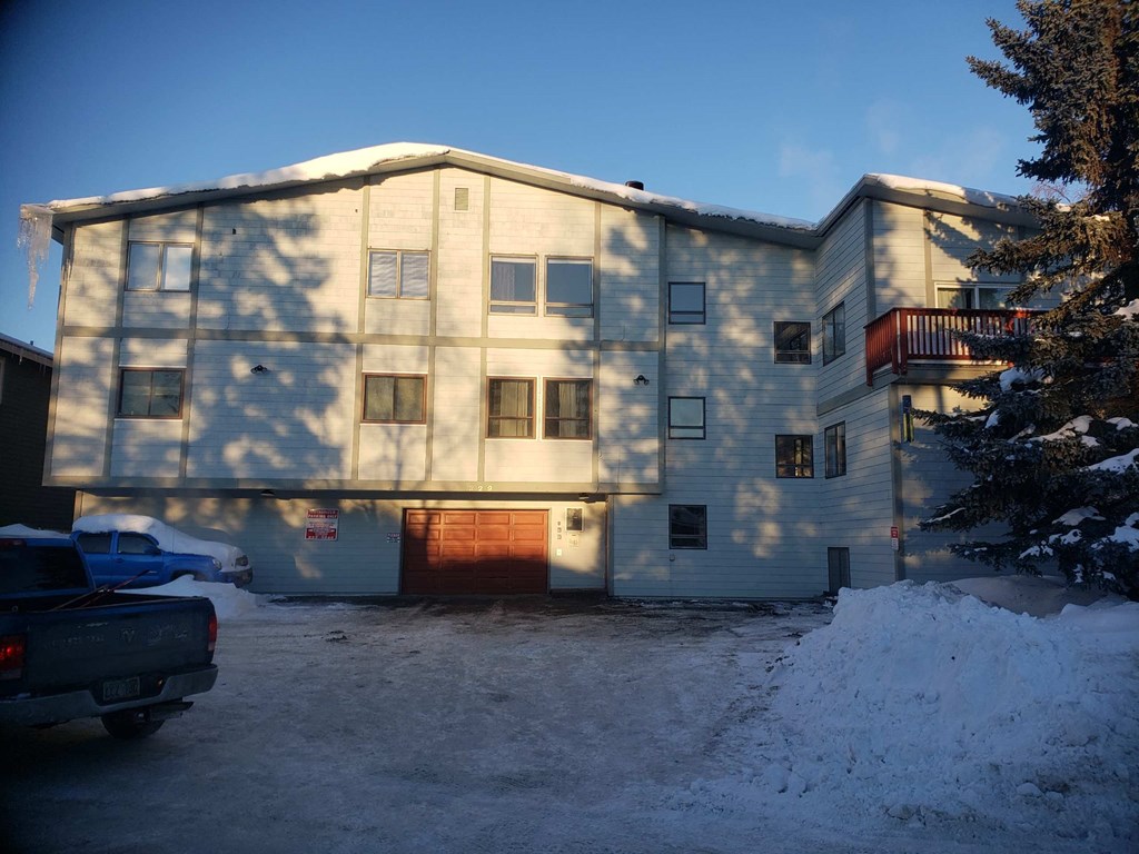 A large building with a truck parked in front of it.