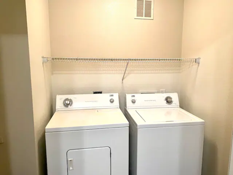 a laundry room with two washes and a dryer