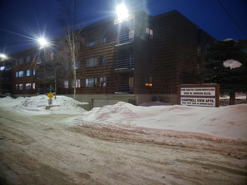 a city street at night covered in snow