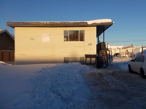A house with a car parked in front of it.