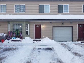 a house with a garage door in the snow