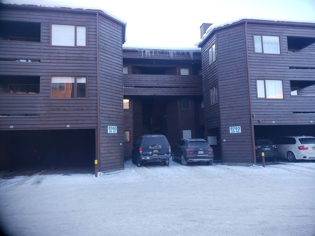 A parking garage with cars parked in it.