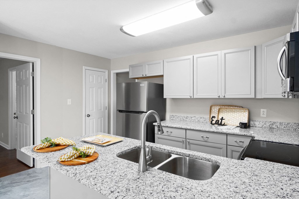 an open kitchen with granite counter tops and stainless steel appliances