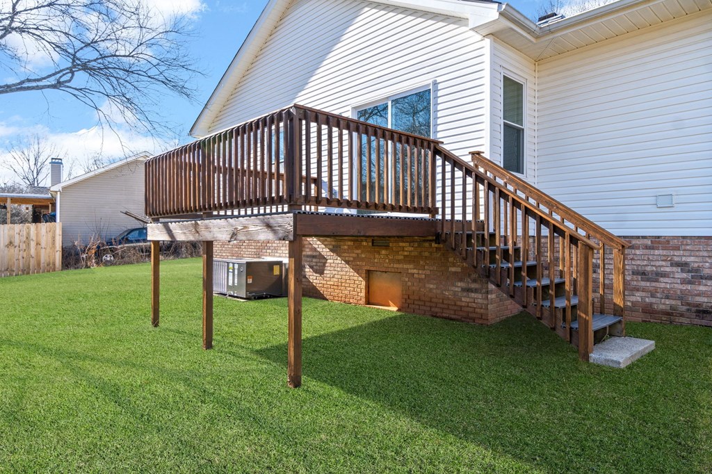 a wooden deck on the side of a house