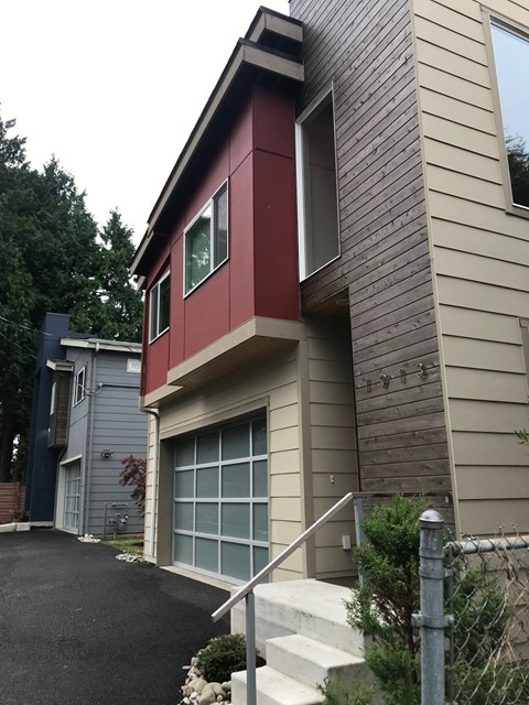 A modern house with a red and beige exterior.
