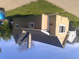 a reflection of a house with a grassy roof