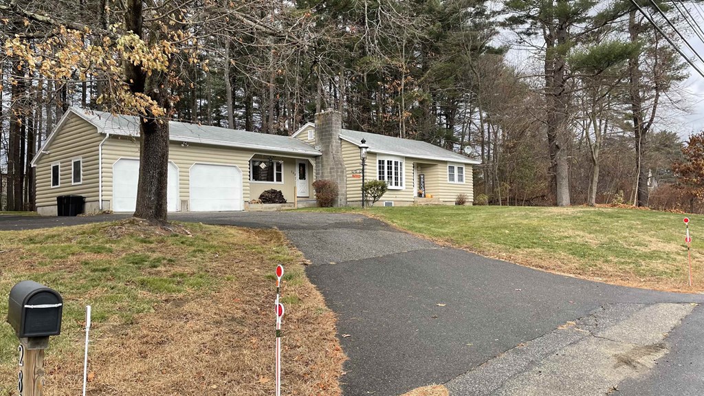 A house with a driveway and a mailbox in front.
