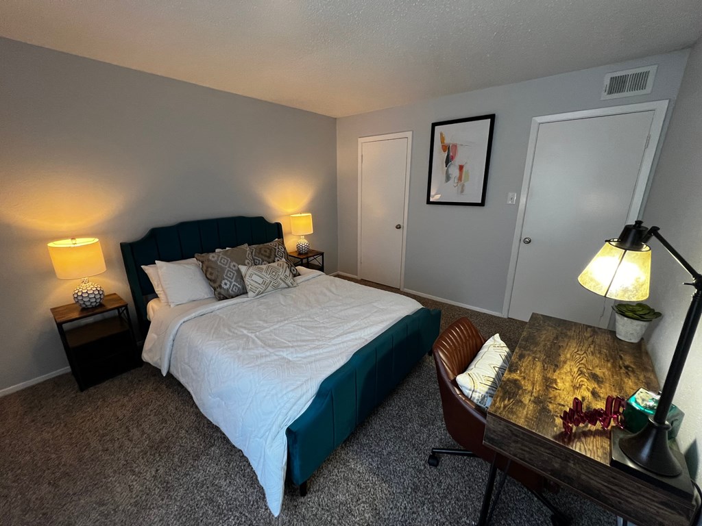 a bedroom with a bed and a desk