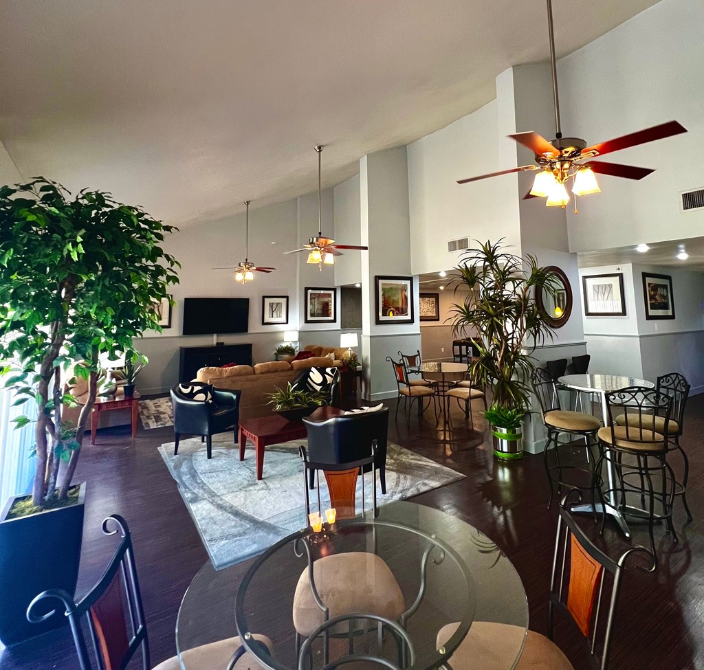 a living room and dining room with a glass table and chairs
