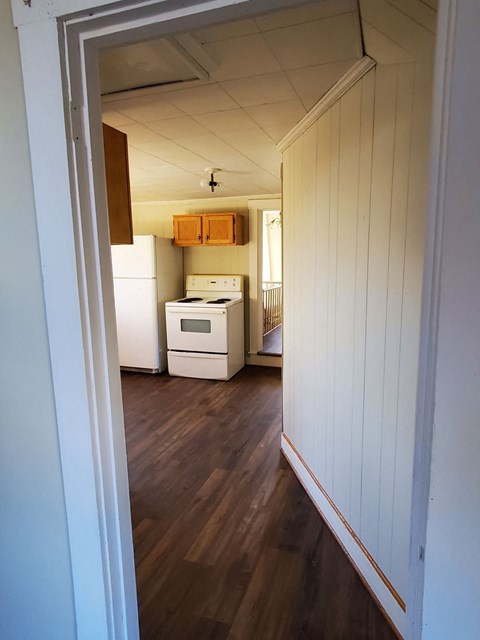 a view of the kitchen from the hallway with the door open