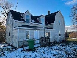 a white house with snow on the ground