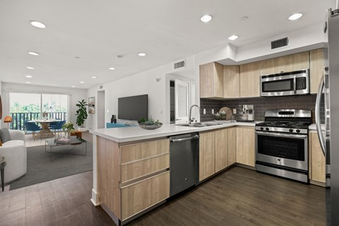 a large kitchen with wooden cabinets and stainless steel appliances