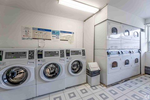 A row of washing machines in a laundromat.
