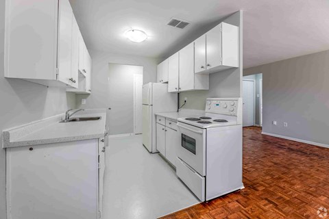 A kitchen with white appliances and cabinets.