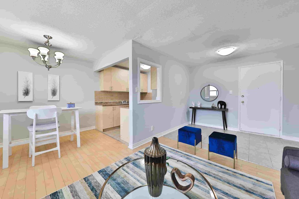 A dining room with a white table and chairs.