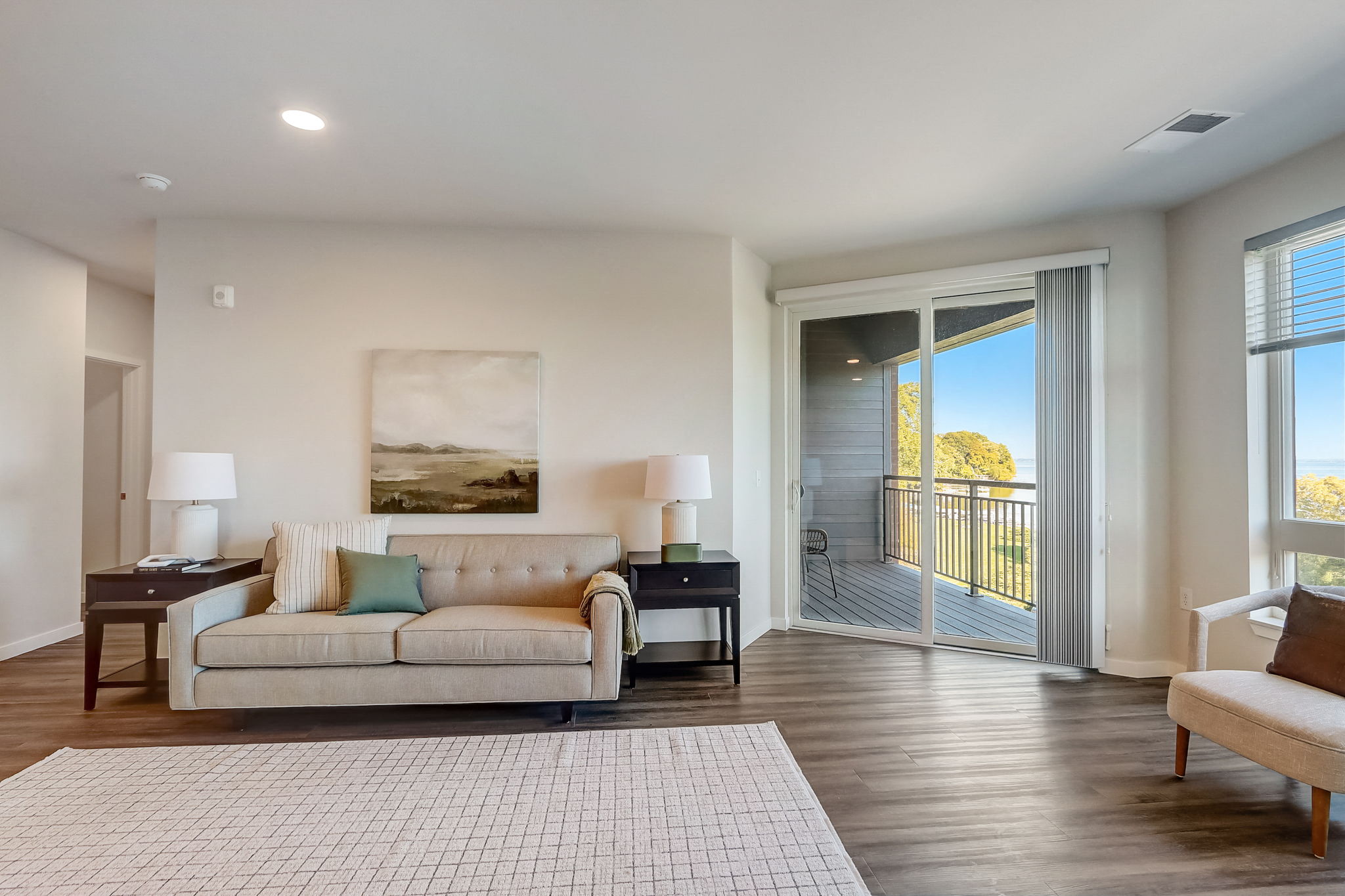 a living room with a couch and a door to a balcony