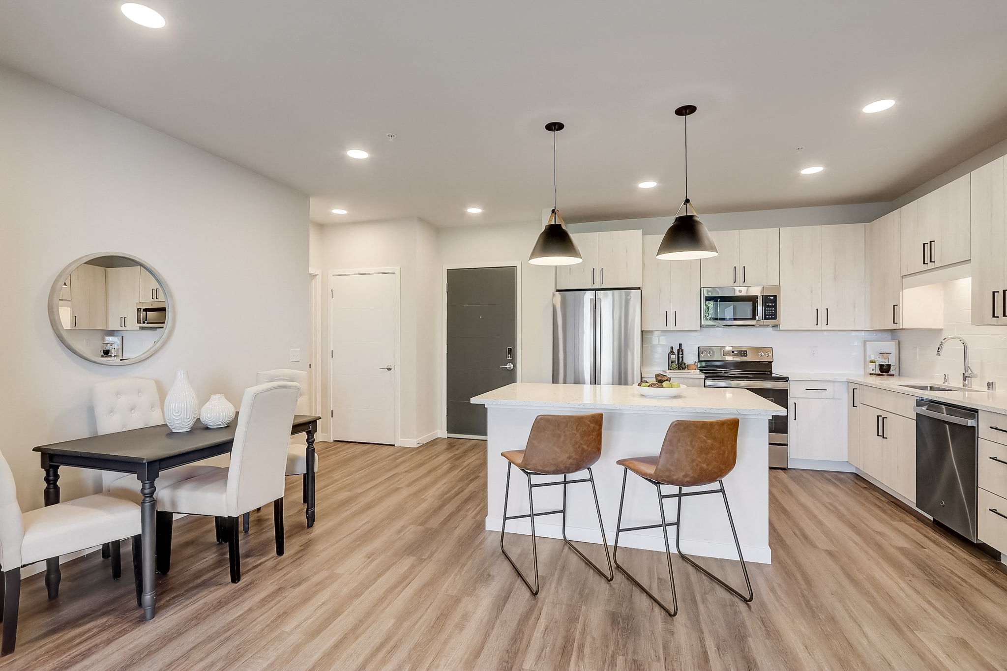 an open kitchen and dining area with a table and chairs