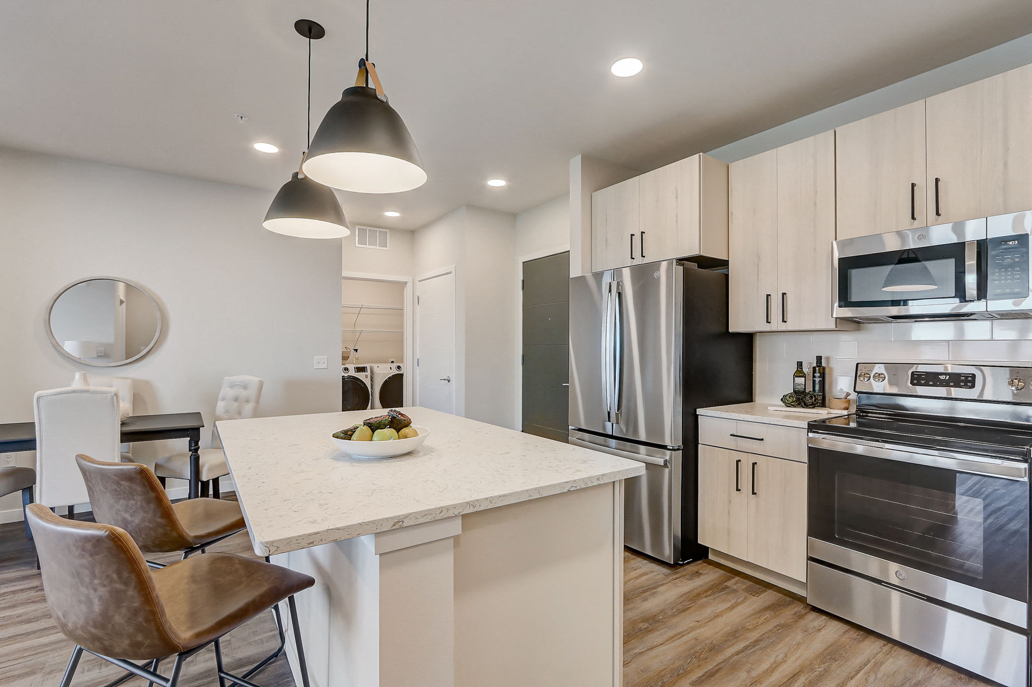 a kitchen with stainless steel appliances and a marble counter top