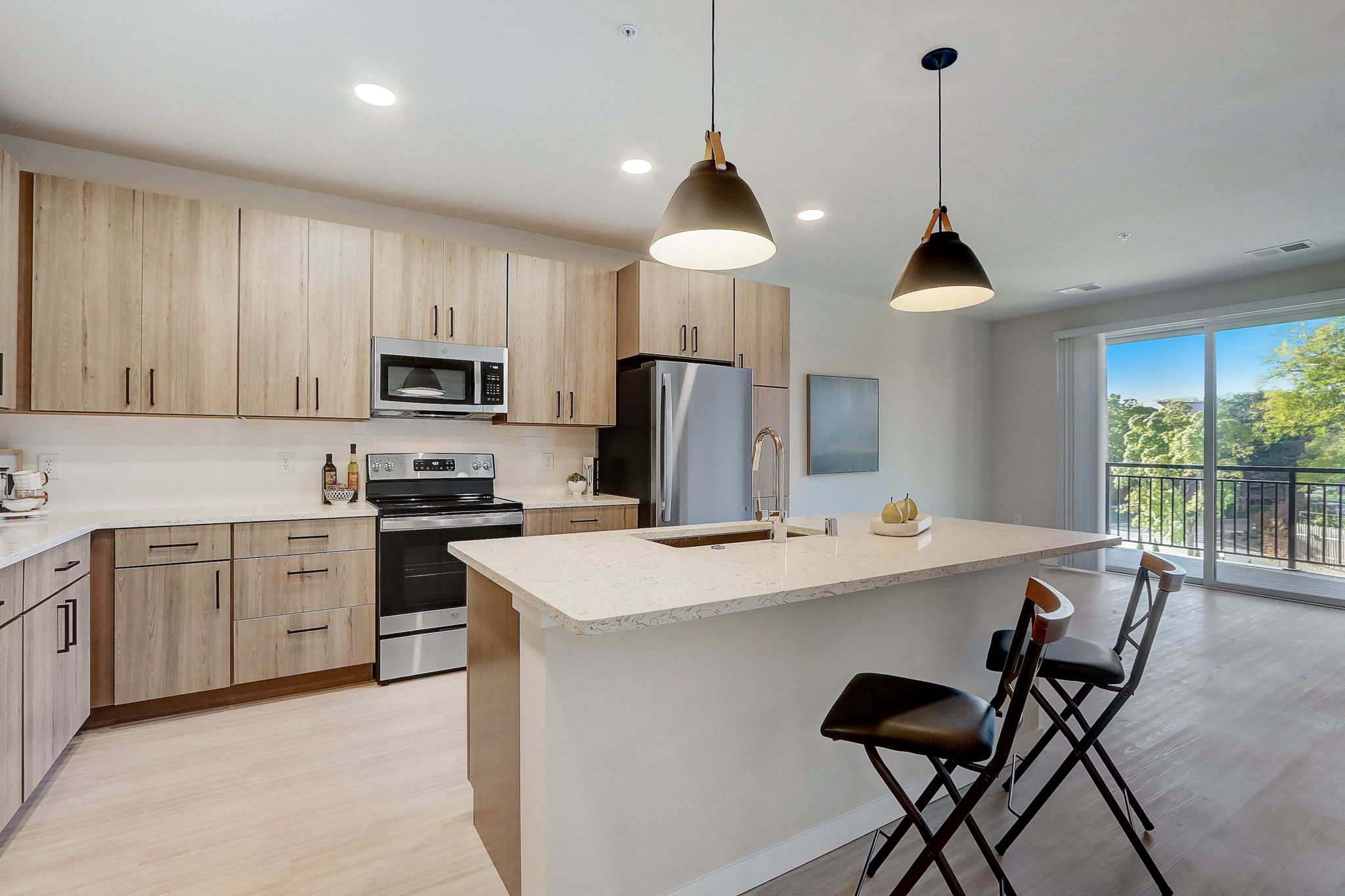 an open kitchen with a large island with stools