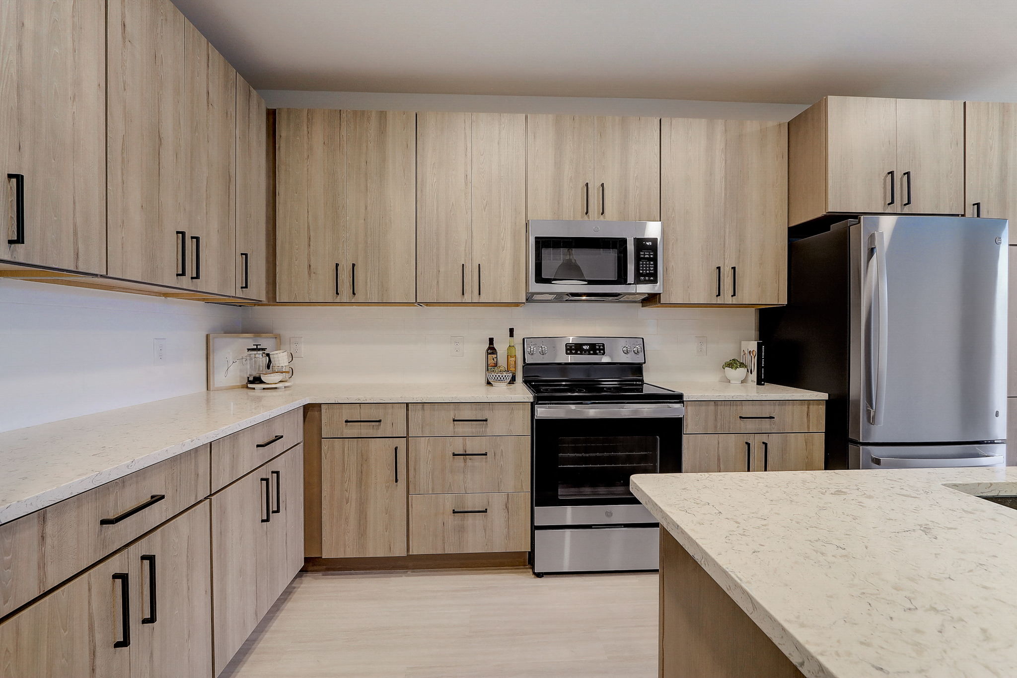a kitchen with wooden cabinets and stainless steel appliances