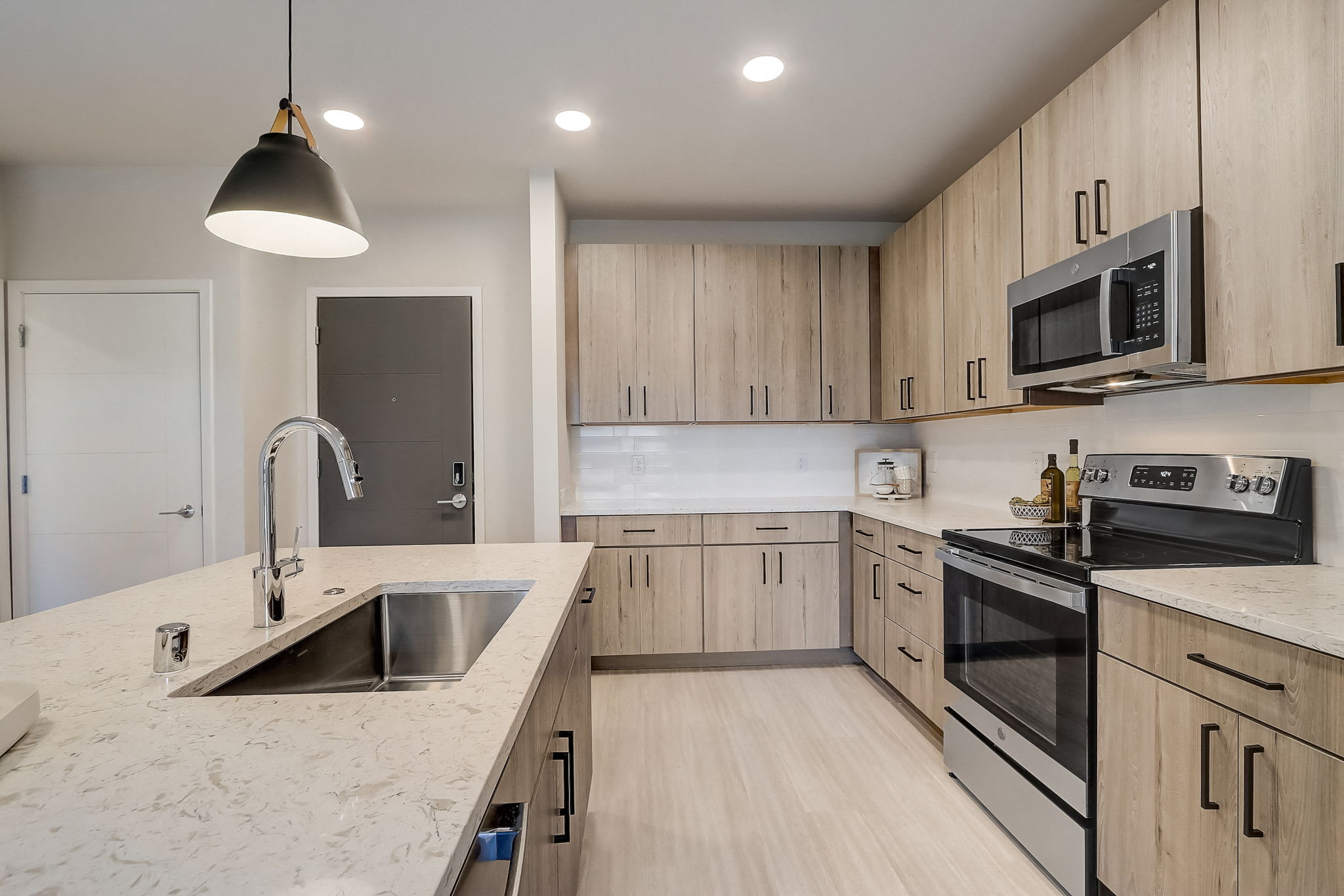 a kitchen with marble counter tops and wooden cabinets