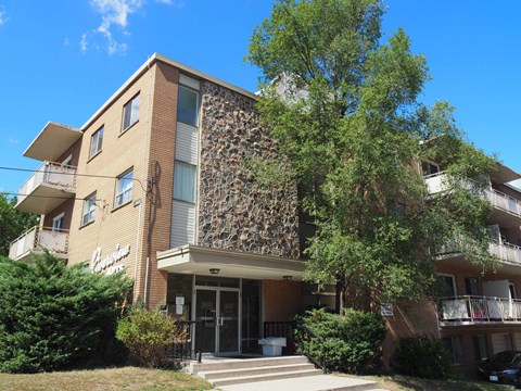 A building with a stone facade and a balcony.