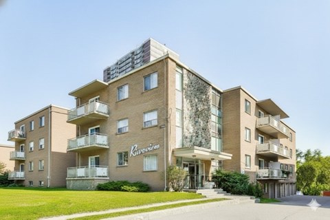 A large apartment building with the name "Praveen" on the front.