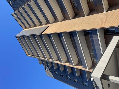 A tall building with a blue sky in the background.