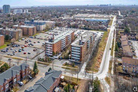 A view of a city from a high vantage point, showing buildings, roads, and vehicles.