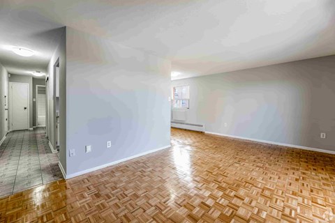 A room with a wooden floor and white walls.