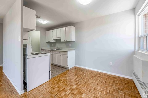 A kitchen with white appliances and cabinets.